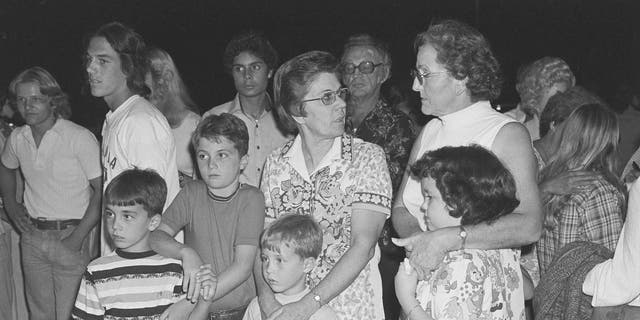 Families of the 26 children who were abducted from their school bus along with the bus driver await word of their fate outside police headquarters in Chowchilla, July 16, 1976.