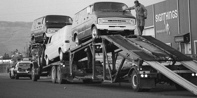 A transport driver secures one of three vans recovered by Alameda County Sheriff's Deputies from a warehouse in San Jose, California, July 24, 1976. 