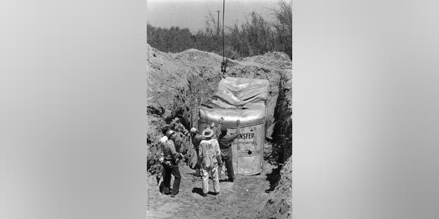 In this July 20, 1976 file photo, officials remove a truck buried at a rock quarry in Livermore, Calif., in which 26 Chowchilla school children and their bus driver, Ed Ray were held captive.