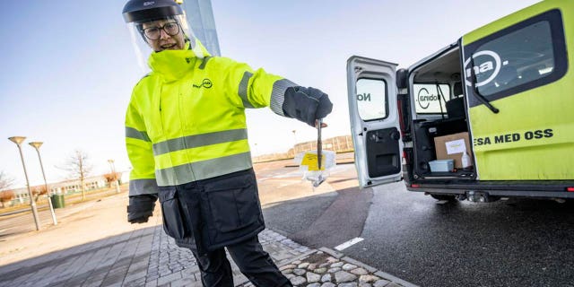 A member of staff collects the last COVID-19 PCR tests, at the Covid testing site of Svagertorp, Malmoe, Sweden, Tuesday, Feb. 8, 2022.