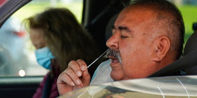 Jose Alfredo De la Cruz and his wife, Rogelia, self-test for COVID-19 at a No Cost COVID-19 Drive-Through event provided the GUARDaHEART Foundation for the City of Whittier community and the surrounding areas at the Guirado Park in Whittier, Calif., on Tuesday, Jan. 25, 2022. 