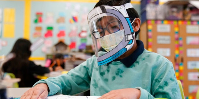 Students wear masks and face shields in a 4th grade class during the COVID-19 pandemic on January 12, 2022 at Washington Elementary School in Lynnwood, California. 