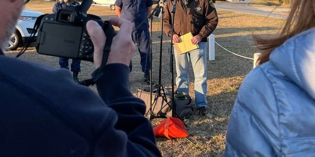 Carteret County Sheriff Asa Buck provides an update Monday on a plane crash in North Carolina.  He said one body had been recovered and it appeared that none of the eight people outside the plane had survived. 