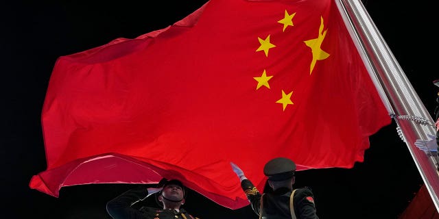 The Chinese flag is raised during the opening ceremony of the 2022 Winter Olympics.