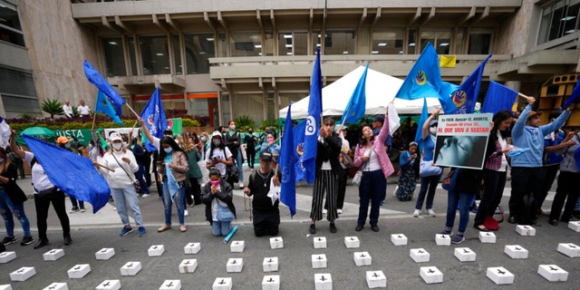 Anti-abortion activists protest outside the Constitutional Court where they placed tiny, symbolic coffins as judges continue discussions on the decriminalization of abortion in Bogota, Colombia, Monday, Feb. 21, 2022.