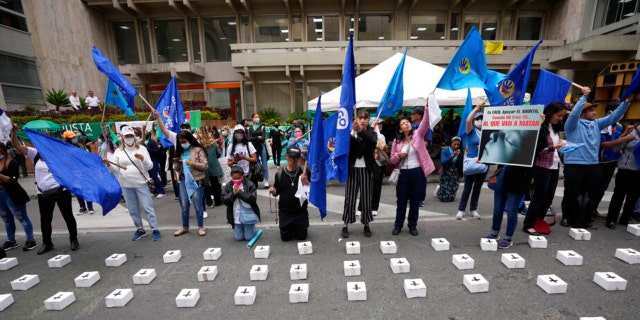 Anti-abortion activists protest outside the Constitutional Court where they placed tiny, symbolic coffins as judges continue discussions on the decriminalization of abortion in Bogota, Colombia, Monday, Feb. 21, 2022.
