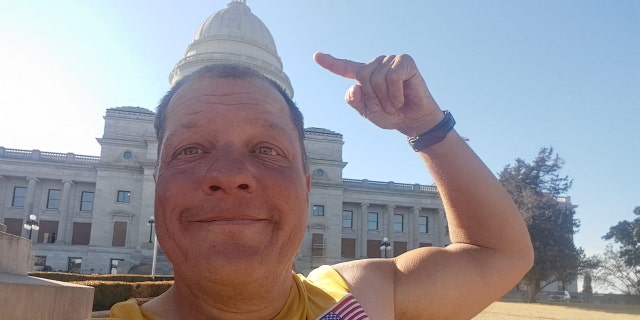 Bob Burns in front of the Arkansas State Capitol. He is cycling to all 50 US capitals this year. "One capital at a time," He said. 