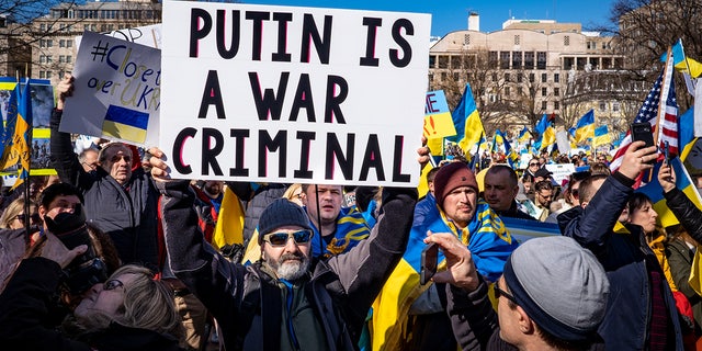 People participate in a pro-Ukrainian protest in Lafayette Park near the White House on February 27, 2022, in Washington, DC. Many U.S. cities have seen rallies in support of Ukraine over the weekend as the invasion by Russian forces continues.