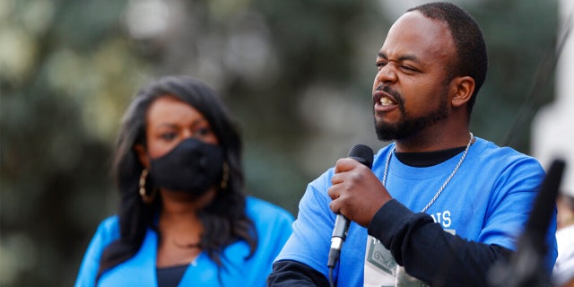 FILE: Greg Bailey, front, speaks at a news conference about the death of his son, De'Von, during a police stop in Aug. 2019 in Colorado Springs, Colo.