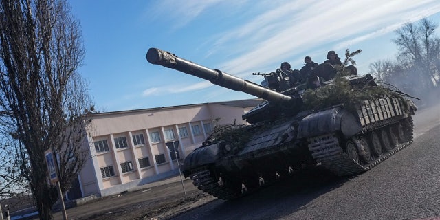 A tank of Ukrainian forces moves as following Russia's military operation on February 24, 2022, in Chuhuiv town, Kharkiv Oblast, Ukraine.
