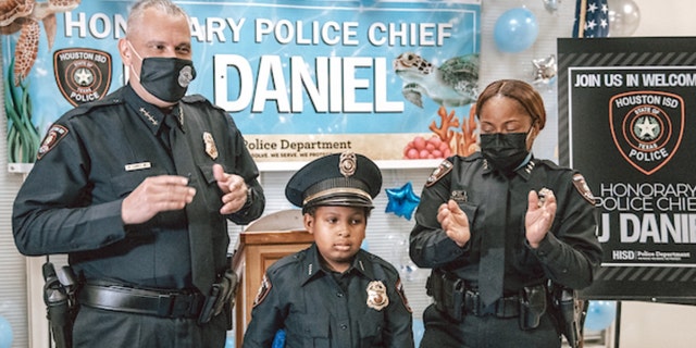 Devarjaye "D.J." Daniel, 10, is sworn into his 100th law enforcement agency. (Houston Independent School District)