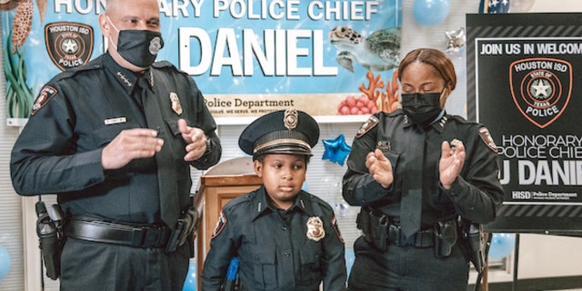Devarjaye "D.J." Daniel, 10, is sworn into his 100th law enforcement agency. (Houston Independent School District)