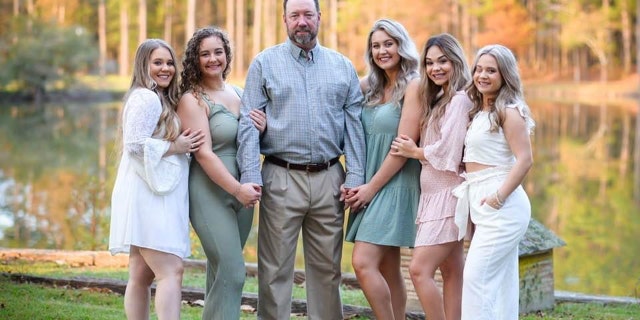 "Mark, my husband, has just been a loving example to the girls, of what a dad is supposed to be," Durrence told Fox News Digital of her husband. Mark Durrence (center) is pictured with his daughters.