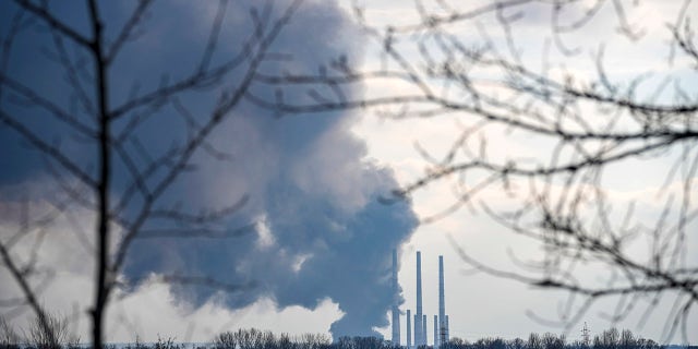 Smoke billows from a power and heating plant as it was shelled in Shchastya, in the Luhansk region, eastern Ukraine, Tuesday, Feb. 22, 2022. (AP Photo/Vadim Ghirda)