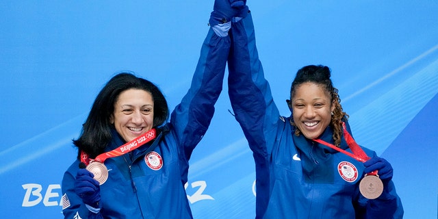 Elana Meyers Taylor and Sylvia Hoffman of the United States celebrate winning the bronze medal in the women's bobsled at the 2022 Winter Olympics, Saturday, Feb. 19, 2022, in the Yanqing district of Beijing.