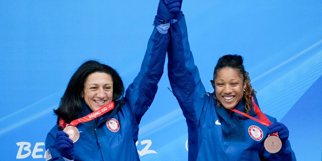Elana Meyers Taylor and Sylvia Hoffman of the United States celebrate winning the bronze medal in the women's bobsled at the 2022 Winter Olympics, Saturday, Feb. 19, 2022, in the Yanqing district of Beijing.