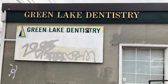 This dental office building front bears the scars of graffiti in the Green Lake section of north central Seattle, Washington, Feb. 2022.