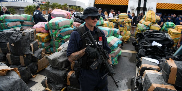 US Coast Guard personnel stand on the deck of Cutter James as they offload approximately $1.06 Billion in cocaine, marijuana at the Port Everglades in Fort Lauderdale, Florida on February 17, 2022.