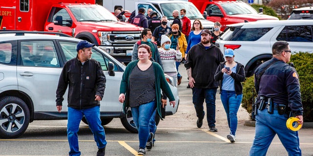 Customers and employees are guided out of a Fred Meyer grocery store after a fatal shooting at the business on Wellsian Way in Richland, Wash., Monday, Feb.  7, 2022.