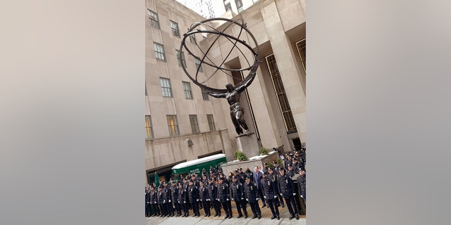 Police are shown on Feb. 2, 2022, in front of Atlas in Rockefeller Center in midtown Manhattan, across the street from St. Patrick's Cathedral. NYPD Officer Wilbert Mora died after an ambush in Harlem. His partner, Officer Jason Rivera, also died from gunshot wounds received during the same incident. Both men were in their 20s.