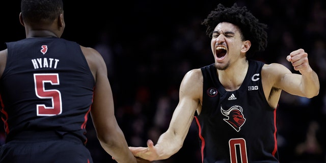 Rutgers guard Geo Baker (0) celebrates with Aundre Hyatt during the second half of the team's NCAA college basketball game against Illinois on Wednesday, Feb. 16, 2022, in Piscataway, N.J.