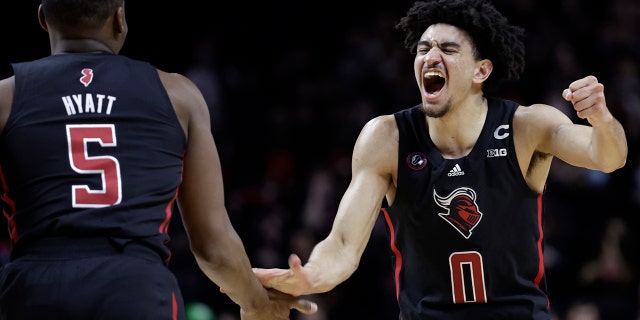 Rutgers guard Geo Baker (0) celebrates with Aundre Hyatt during the second half of the team's NCAA college basketball game against Illinois on Wednesday, Feb. 16, 2022, in Piscataway, N.J.
