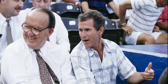 Il commissario della MLB Fay Vincent e il socio generale amministratore dei Texas Rangers George W.  Bush guarda durante la partita dei Texas Rangers nel luglio 1990 all'Arlington Stadium di Arlington, in Texas.