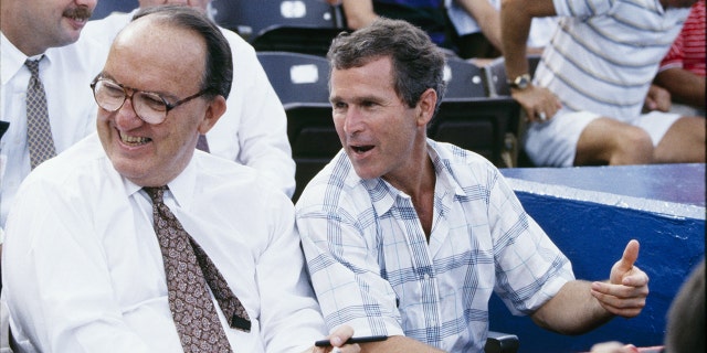 MLB Commissioner Fay Vincent and Texas Rangers managing general partner George W. Bush watch a July 1990 Texas Rangers game at Arlington Stadium in Arlington, Texas.