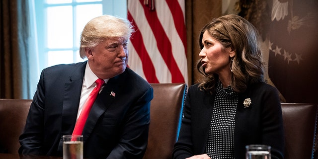 Then-President Trump speaks with then-South Dakota Gov.-elect Kristi Noem during a meeting at the White House, Dec. 13, 2018.