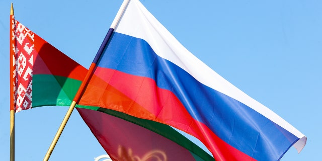 Russian and Belarusian flags wave during a wreath laying ceremony at the Victory Monument. 