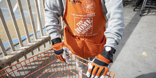 A worker wearing a Home Depot branded apron pushes a shopping cart at a store in Colma, California, U.S., on Thursday, Feb. 18, 2021. Photographer: David Paul Morris/Bloomberg
