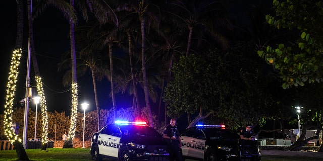 A Miami Beach police officer stands guard on Ocean Drive in Miami Beach, Florida, on March 22, 2021.