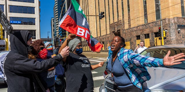 A woman argues with protestors for blocking a street. (Photo by Kerem Yucel / AFP) (Photo by KEREM YUCEL/AFP via Getty Images)