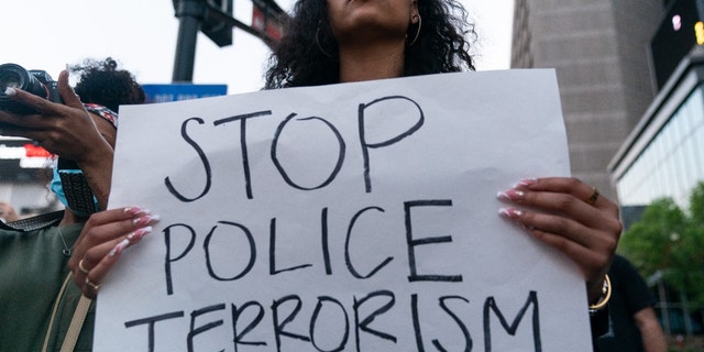 Qri Montague holds a sign while marching following the guilty verdict the trial of Derek Chauvin on April 20, 2021, in Atlanta, Georgia.(Photo by ELIJAH NOUVELAGE/AFP via Getty Images)