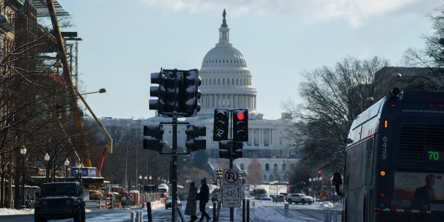 14-year-old girl charged in DC shooting on Pennsylvania Ave 4 Pedestrians cross Pennsylvania Avenue near the US Capitol in Washington, DC, Jan. 7, 2022.