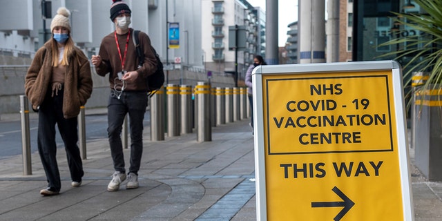 People walk past a COVID-19 vaccination center in Brent, northwest London, Britain, on Jan. 28, 2022. (Photo by Ray Tang/Xinhua via Getty Images)