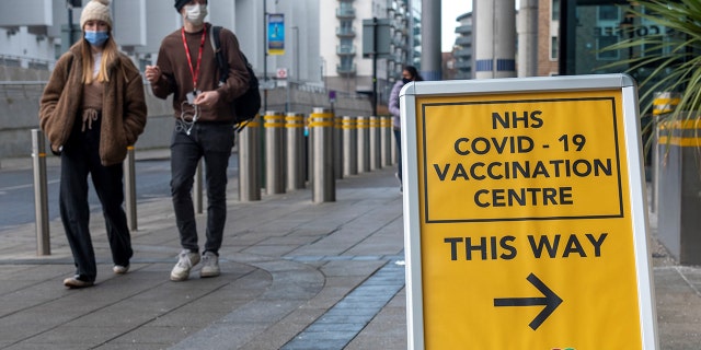 People walk past a COVID-19 vaccination center in Brent, northwest London, Britain, on Jan. 28, 2022. (Photo by Ray Tang/Xinhua via Getty Images)