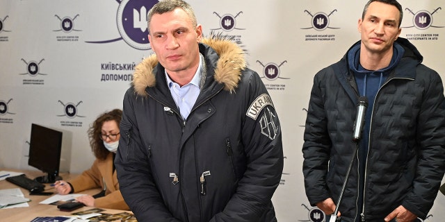 Kyiv mayor Vitali Klitschko (left) and his brother and former Ukrainian boxer Wladimir Klitschko speak to the press during a visit to a volunteer recruitment center in Kiev Feb. 2, 2022.