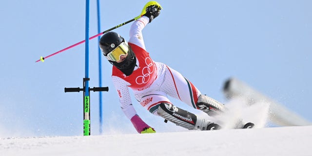 Bulgaria's Eva Vukadinova (R) reacts as a tool is still on the pole during the first run of the women's slalom during the Beijing 2022 Winter Olympic Games at the Yanqing National Alpine Skiing Centre in Yanqing on February 9, 2022. 