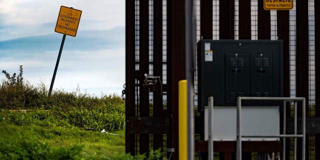 A sign just on the other side of the border fence warns of trespassing in Brownsville, Texas, on February 11, 2022. (Photo by Jim WATSON / AFP) (Photo by JIM WATSON/AFP via Getty Images)