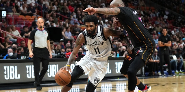 Kyrie Irving #11 of the Brooklyn Nets drives to the basket during the game against the Miami Heat on February 12, 2022 at FTX Arena in Miami, Florida. 