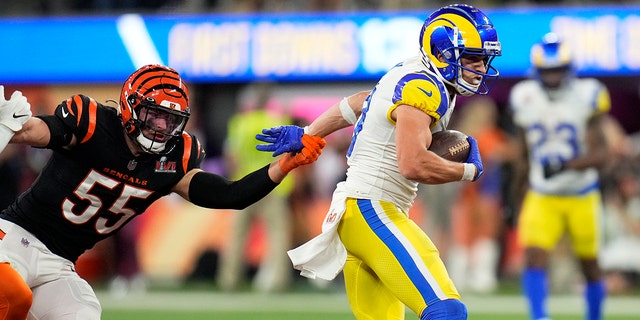 Wide receiver Cooper Kupp, right, of the Los Angeles Rams runs away from linebacker Logan Wilson, left, of the Cincinnati Bengals during the fourth quarter of the NFL Super Bowl LVI football game at SoFi Stadium in Inglewood, on Sunday, Feb. 13, 2022. 
