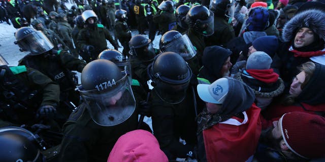 Police clash with convoy protesters in Ottawa, Ontario, on Feb. 18, 2022.