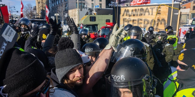 Protestors and the police face off in blockaded streets surrounding Parliament Hill on February 18, 2022 in Ottawa, Ontario, Canada. (Photo by Alex Kent/Getty Images)