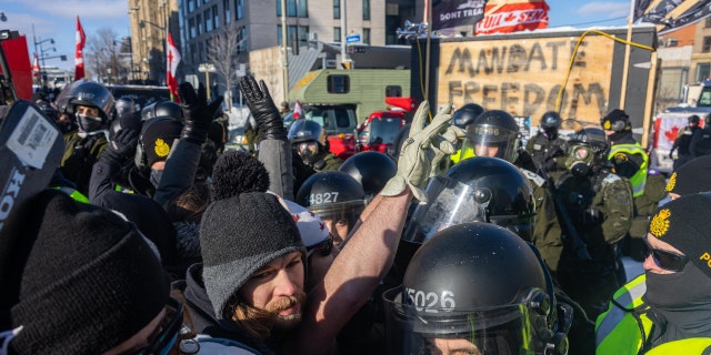 Protestors and the police face off in blockaded streets surrounding Parliament Hill on February 18, 2022 in Ottawa, Ontario, Canada. (Photo by Alex Kent/Getty Images)