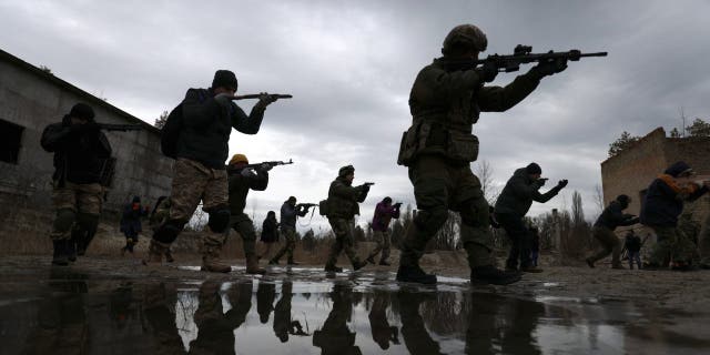 Members of Ukraine's Territorial Defense Forces participate in a drill during training at a former asphalt factory on the outskirts of Kyiv, Ukraine, on Saturday, Feb. 19, 2022. The U.S. has ramped up warnings of a possible Russian attack on Ukraine, Russian officials said no invasion of Ukraine was underway and none was planned. 