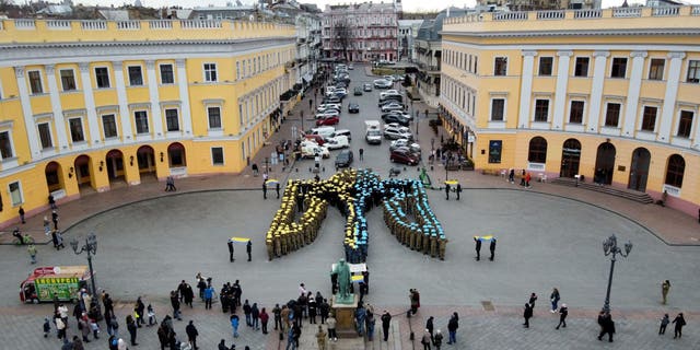 Some 450 cadets of the Odessa State University of Internal Affairs, the Military Academy of Odessa and the Institute of the Naval Forces of Ukraine, form the coat of arms of Ukraine to show unity, in Odessa, southern Ukraine, on February 19, 2022 (Photo by Oleksandr GIMANOV / AFP) (Photo by OLEKSANDR GIMANOV/AFP via Getty Images)