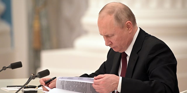 Russia's President Vladimir Putin signs decrees to recognize independence of the Donetsk and Lugansk People's Republics. (Photo by Alexei NikolskyTASS via Getty Images)