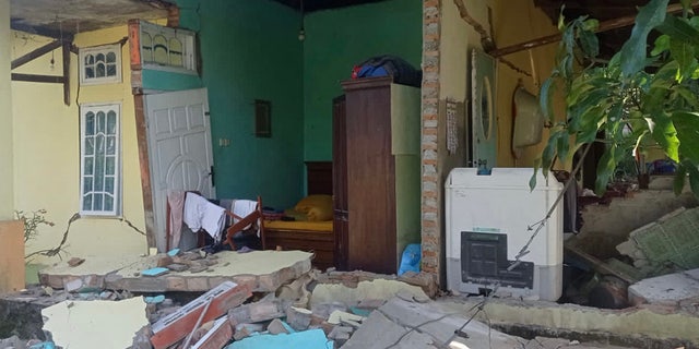 This picture shows a damaged house after a 6.2 magnitude earthquake in Kajai village, West Pasaman on February 25, 2022. 