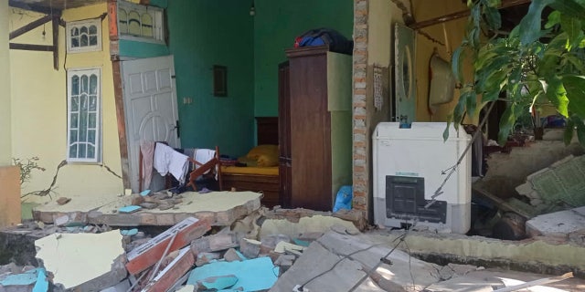 This picture shows a damaged house after a 6.2 magnitude earthquake in Kajai village, West Pasaman on February 25, 2022.